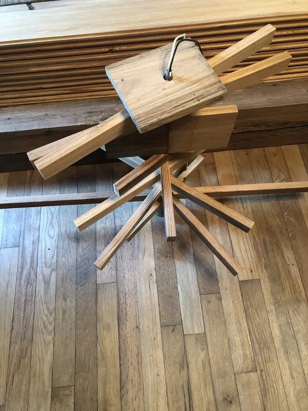 Bundled cut oak flooring strips laid across an existing plank floor for a repair